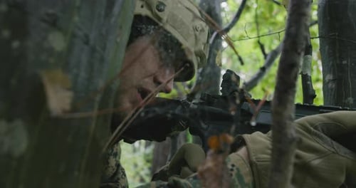Fully Equipped Rifle Soldier Wearing Camouflage Uniform Attacking Enemy Rifle in Firing Position in