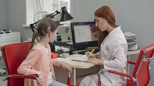 Doctor Meeting with a Child in Medical Office