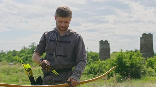 a Young Guy Shoots a Bow at a Target in Nature and Hits the Target the Arrow Pierces the Target for