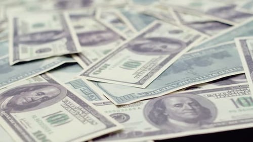 Many Dollar Bills Rotate in Closeup