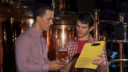 Two Brewers Examining Craft Beer, Working at the Brewery