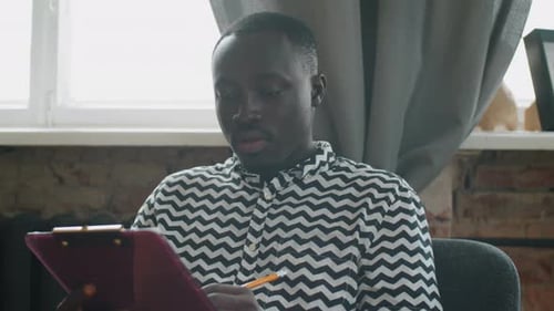 African Student Studying Online via Web Call at Home