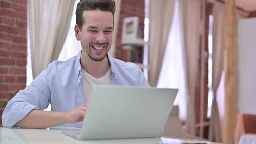 Enthusiastic Adult Man Video Calling On Laptop