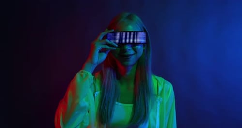 Young Asian woman playing metaverse virtual reality digital technology game with VR goggle.