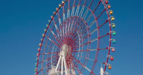 Colorful Ferris Wheel Spinning on a Sunny Day