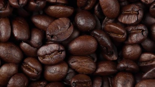 close up of roasted coffee beans rotating, seeds of coffee