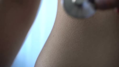 Hand of Male Therapist Listening to Patient Belly With Stethoscope at Hospital