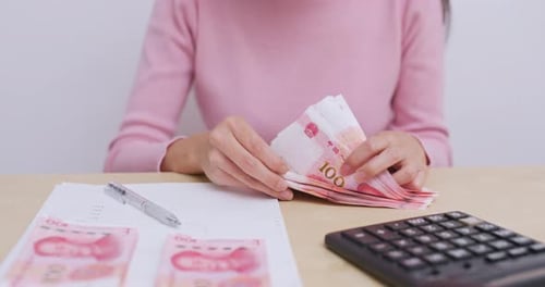 Counting Chinese Money at a Desk