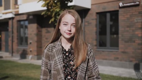 Pretty Girl with Blonde Hair Poses Outdoors