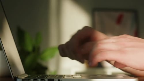 Hands Typing on Laptop Computer in Home Office