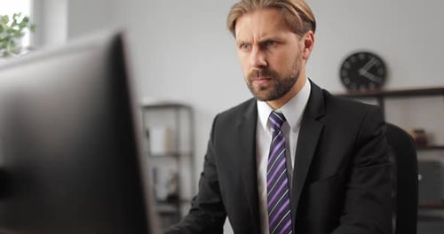 Focused Businessman Using Computer at Office