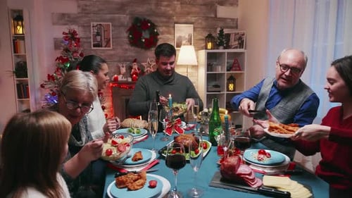 Family Christmas Dinner Gathering Around Table