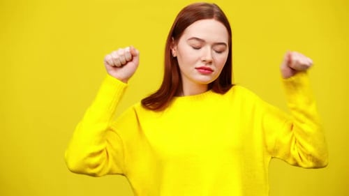 Woman Expressively Dancing on Yellow Background