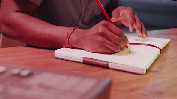 Hands of Songwriter Writing Lyrics in Notepad in Home Recording Studio ...