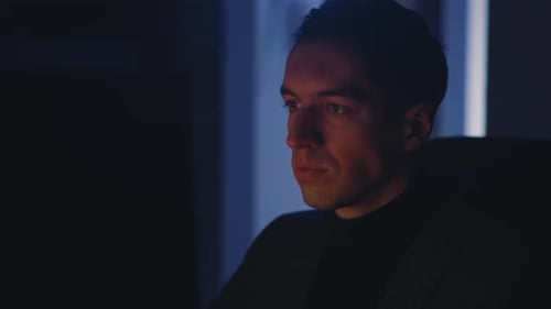 Young Businessman Man Working at Laptop Computer Late at Night