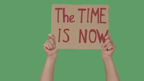 Hands Holding Cardboard Sign on Green Screen