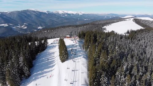 Aerial Ski Slopes with Skiers and Ski Lifts on Ski Resort. Snowy Mountain Forest
