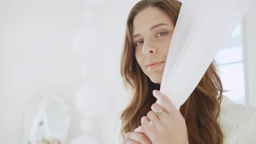 Elegant Woman Posing with White Fabric