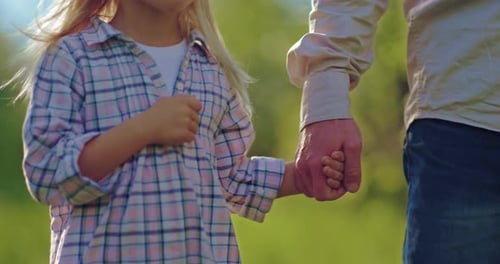Happy Child and Dad are Holding Hands and Walking in Park Details View Prores