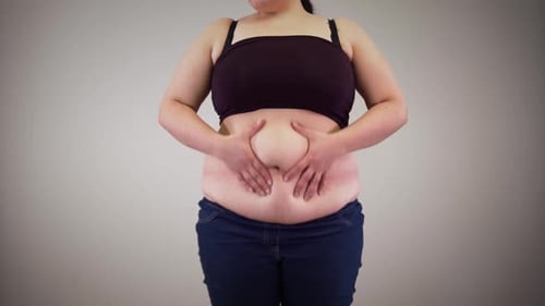 Adult Examining Midsection of Body in Studio