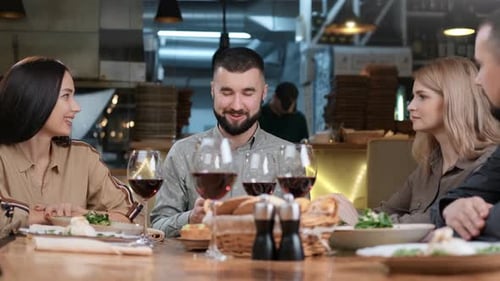 Two Happy Couple Enjoy Friendly Conversation at Restaurant Together Having Fun