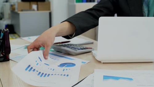 Financial Analysis at Office Desk With Laptop