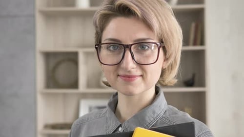 Smiling Woman with Blond Hair and Glasses Indoors