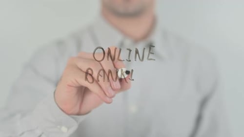 Writing Online Banking with Marker on Glass