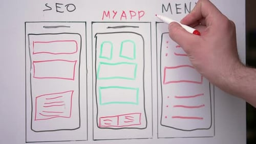 The hand of a young guy is writing on a white board application development