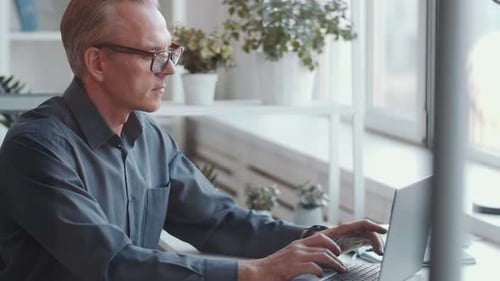 Professional Businessman Working on Laptop at Office Desk