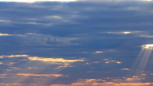 Sun Rays Shining Through Cloudy Sky With Fluffy Clouds. Sunset Sky Natural Background.