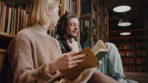 Students Reading Books Together in Library