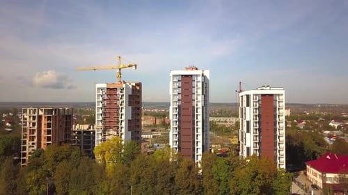 Aerial view of high residential apartment buildings under construction. Real estate development.