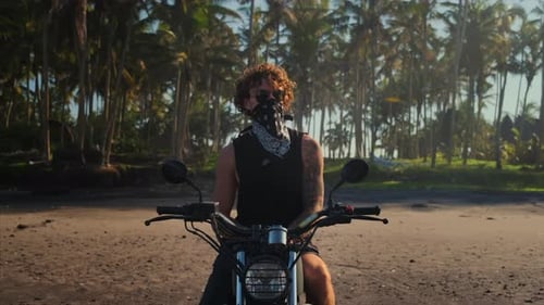 Bold Tattooed Biker on Tropical Beach