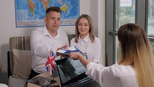 Young Couple Receives Tickets from Travel Agent