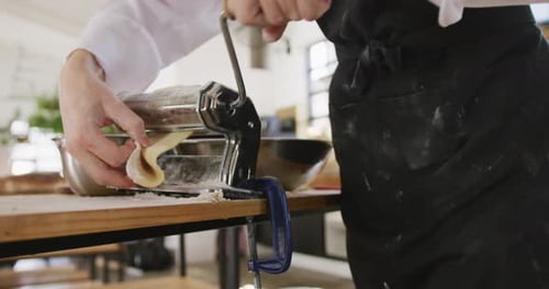 Person Uses Pasta Maker in Kitchen