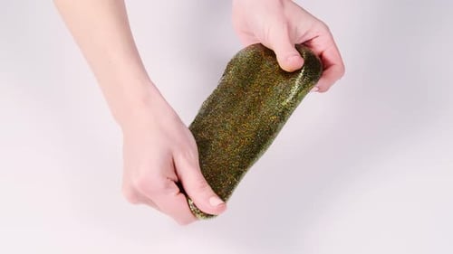 Teenager's hands stretching sticky substance for fun and stress relief