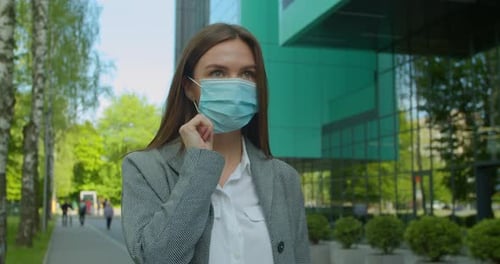 Portrait of a Young Businesswoman Wearing Protective Mask on Street. Concept of Health and Safety