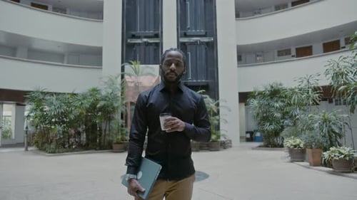 Young African American Businessman Standing Outside Corporate Building
