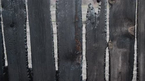 Burnt Fence Boards After a Fire in a Private House