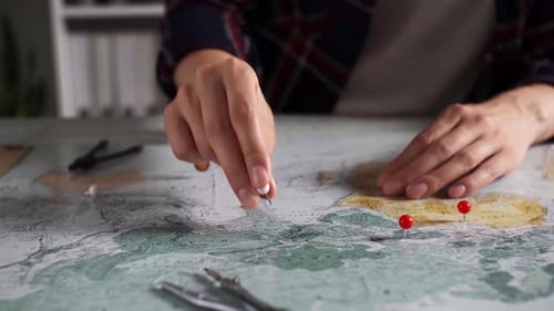 Woman Planning Travel Destinations on a World Map