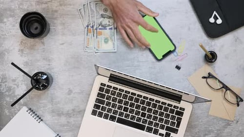 Man presses calculator on smartphone to analyze company charges, expenses and income