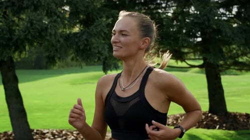Positive Woman Running in Green Park. Athlete Doing Cardio Workout at Morning