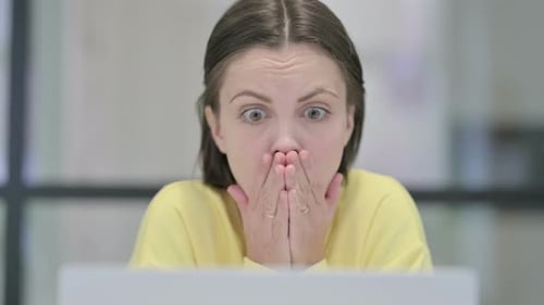 Close Up of Woman Reacting to Loss on Laptop