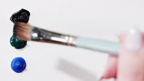 Brush Drawing with Colorful Paint Closeup Black Green and Blue Colours Art Concept