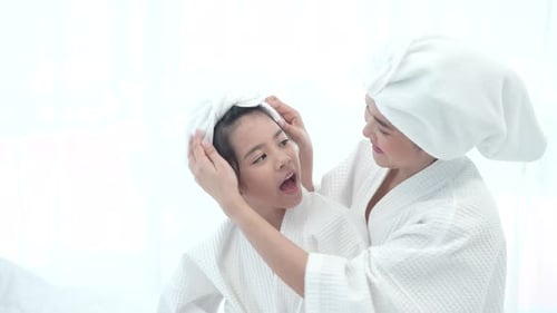 Woman Wraps Girl's Hair in Towel After Bath