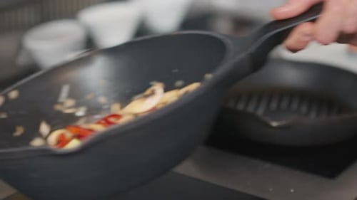Cooking vegetables in a skillet in the kitchen