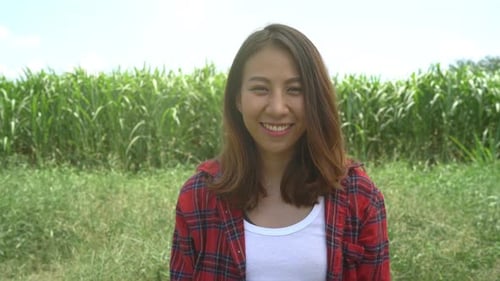 Smiling Woman Standing in Field