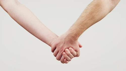 Woman holding man's hand