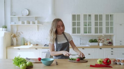 Woman Chopping Vegetables and Dancing in Kitchen